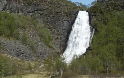 a waterfall on the side of a mountain at Petterbua in Norheimsund