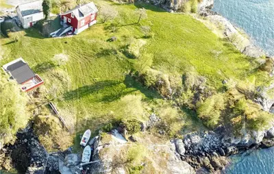 an aerial view of a house on an island in the water at Holiday Home Jondal Torsnes in Jondal