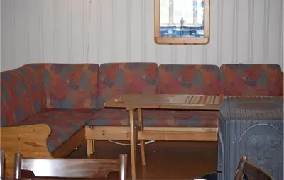 a living room with a couch and a table at Holiday Home Tysse Eikedal in Tysse