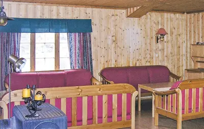 a living room with two chairs and a table and a couch at Holiday Home Tysse Eikedal in Tysse