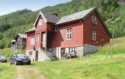 a large red house on top of a hill at Holiday Home Evanger Brekkhuslii in Evanger