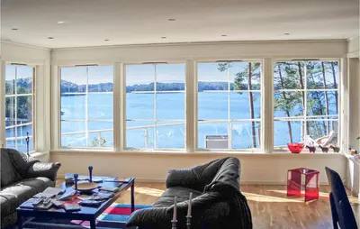 a living room with a view of the water at Gorgeous Home In Hagavik in Hagavik