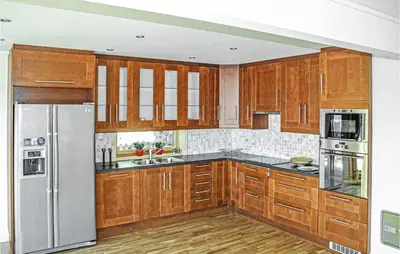 a kitchen with wooden cabinets and stainless steel appliances at Gorgeous Home In Hagavik in Hagavik