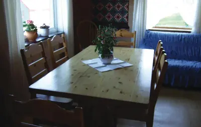 a dining room table with a potted plant on it at Holiday Home Sørbøvåg Sandnes in Sandnes