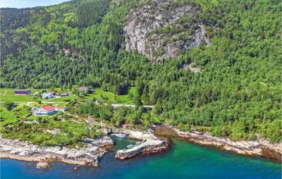an aerial view of a house on a island in the water at Cozy Home In Lavik With House Sea View in Lavik