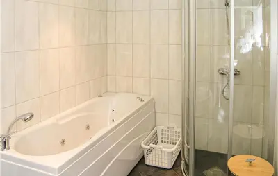 a white bathroom with a tub and a glass shower at Gorgeous Home In Dalsøyra With Kitchen in Dalsøyra