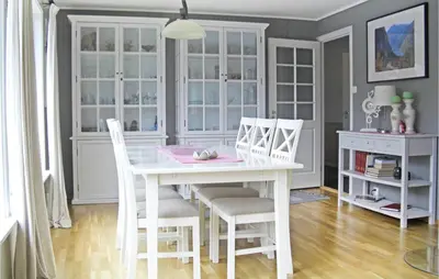 a dining room with a white table and chairs at Gorgeous Home In Dalsøyra With Kitchen in Dalsøyra