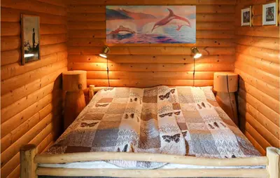 a bedroom with a bed in a log cabin at 2 Bedroom Beautiful Home In Balestrand in Balestrand