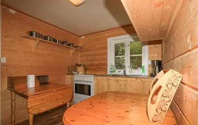 a wooden kitchen with a wooden table and a stove at 2 Bedroom Beautiful Home In Balestrand in Balestrand