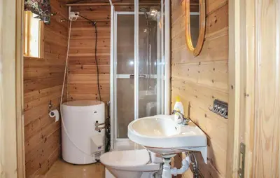 a bathroom with a sink and a toilet and a shower at Stunning Home In Vik I Sogn With Wifi in Espeset