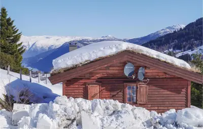a log cabin with snow on the roof at Stunning Home In Vik I Sogn With Wifi in Espeset