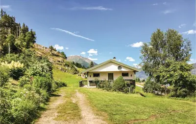 a house on a hill with a dirt road at Holiday Home Balestrand Stokkabø in Balestrand