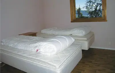 three mattresses sitting in a room with a window at Holiday Home Balestrand Stokkabø in Balestrand