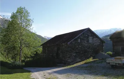 a stone barn with a truck parked in front of it at Beautiful Home In Jostedal With Kitchen in Jostedal
