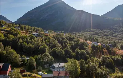 a village in a valley with mountains in the background at Beautiful Home In Jostedal With Kitchen in Jostedal