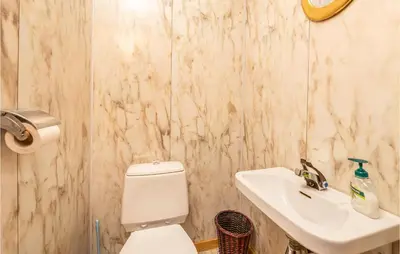 a bathroom with a white toilet and a sink at Beautiful Home In Jostedal With Kitchen in Jostedal