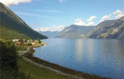a view of a lake with mountains in the background at Naddvik in Årdalstangen