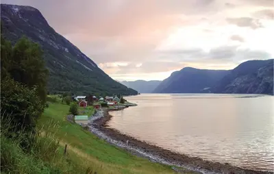 a view of a lake with mountains in the background at Naddvik in Årdalstangen