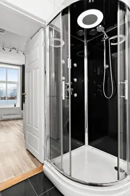 a bathroom with a shower with a glass enclosure at Central and quiet studio apartment in Ålesund in Ålesund