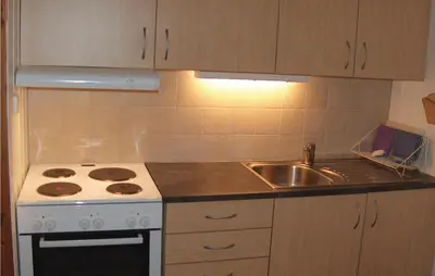 a small kitchen with a stove and a sink at Gorgeous Home In Ålfoten With Sauna in Ålfoten