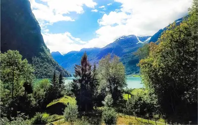 a view of a lake in a valley with mountains at Flåten Hyttegrend in Olden