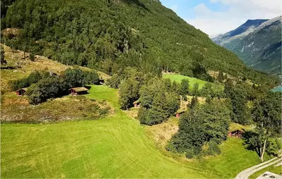an aerial view of a mountain with houses and trees at Flåten Hyttegrend in Olden