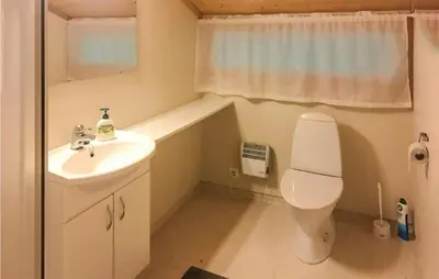 a small bathroom with a toilet and a sink at Flåten Hyttegrend in Olden