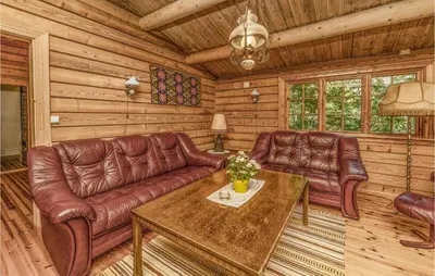 a living room with leather furniture in a log cabin at Beautiful Home In Olden With Sauna in Olden