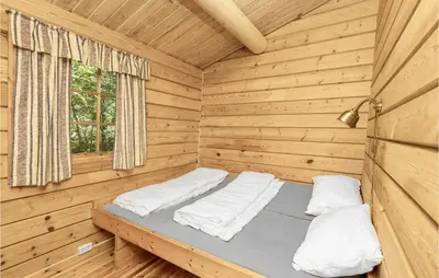 a room with two beds in a wooden cabin at Beautiful Home In Olden With Sauna in Olden