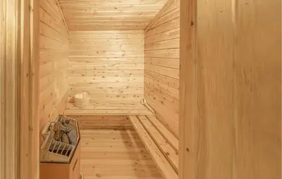 a sauna with wooden walls and a wooden floor at Beautiful Home In Olden With Sauna in Olden