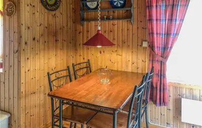 a dining room with a wooden table and chairs at Holiday Home Olden Gjerde in Olden