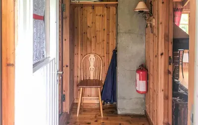 a wooden chair sitting in a hallway next to a fire hydrant at Holiday Home Olden Gjerde in Olden
