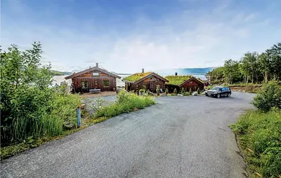 a car is parked in front of a house at Hytte 19 in Ikornnes