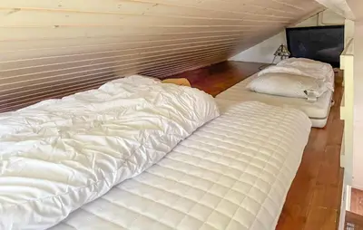 two large white beds sitting in a room at Stunning Home In Stranda With Sauna in Stranda