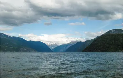 a large body of water with mountains in the background at Stunning Home In Stranda With Sauna in Stranda