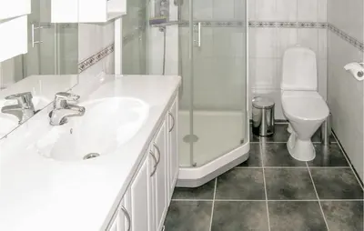 a bathroom with a sink and a shower and a toilet at Sandshamn in Sandshamn