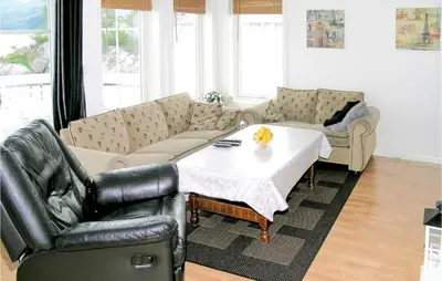 a living room with a couch and a table and chairs at Sandshamn in Sandshamn