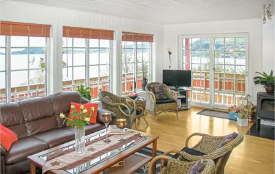 a living room with a couch and chairs at 4 Bedroom Beautiful Home In Hundeidvik in Hundeidvik