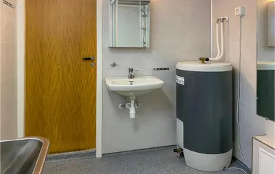 a bathroom with a sink and a toilet and a mirror at Holiday Home Isfjorden Isfjorden in Isfjorden