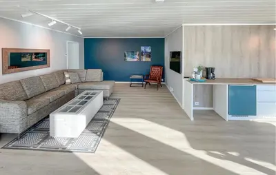 a living room with a couch and a table at Solhavn in Eidsvåg