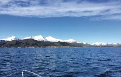 a view of a large body of water with snow covered mountains at Lovely Home In Vågstranda in Hjelvik