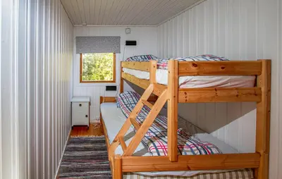a bedroom with two bunk beds in a house at Holiday Home Farstad Rævhaugen in Farstad