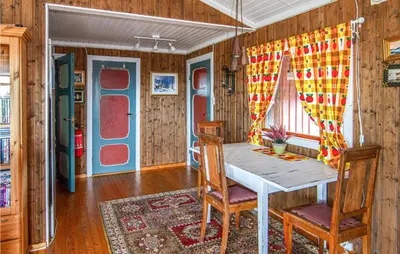 a dining room with a table and two chairs at Holiday Home Farstad Rævhaugen in Farstad