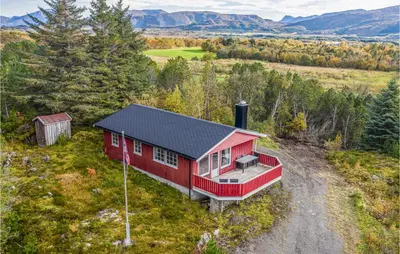 an aerial view of a red house in a field at Holiday Home Farstad Rævhaugen in Farstad