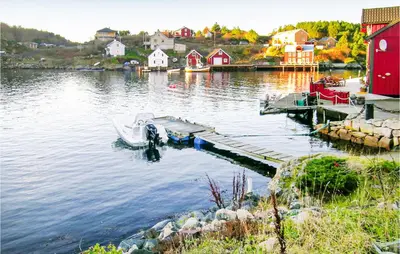 a boat is docked at a dock on a lake at Evastua in Averoy
