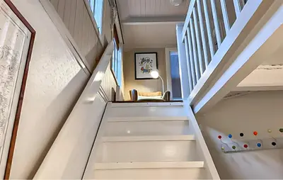 a staircase in a home with a white stair case at Evastua in Averoy