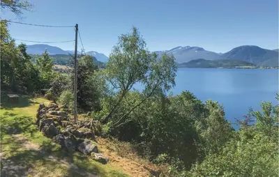 a view of a body of water with a tree at Idavolden in Stangvik