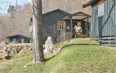 a group of people sitting on the porch of a house at Idavolden in Stangvik