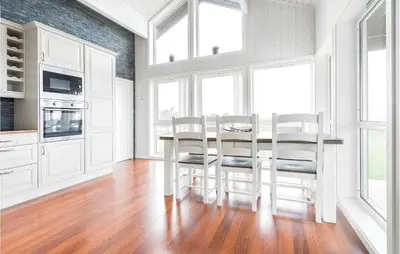 a kitchen with a table and chairs in a room at 4 Bedroom Lovely Home In Kvisvik in Kvisvik