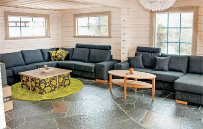 a living room with a couch and a table at Amazing Home In Trysil With Sauna in Trysil